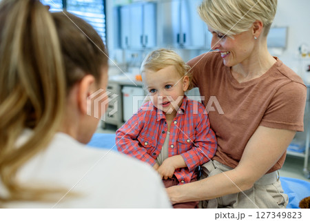 Pediatrician examing little boy during preventive health check up. Pediatrician examing little boy during preventive health check up. 127349823