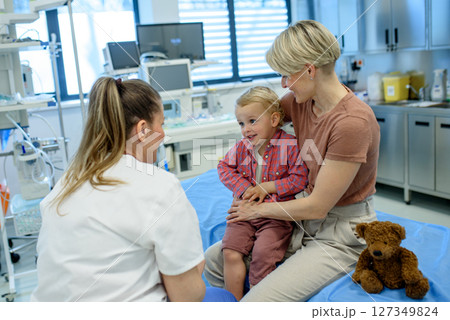 Pediatrician examing little boy during preventive health check up. Pediatrician examing little boy during preventive health check up. 127349824