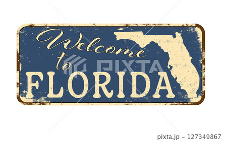 Welcome to Florida. A worn blue plaque with the name and outline of the state. Welcome inscription on the road sign 127349867