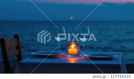 Candlelit Seaside Dinner Table for One at Twilight with Ocean Horizon 127350310
