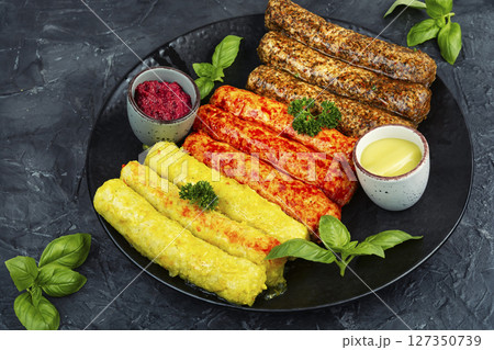 Delicious, uncooked sausages. 127350739