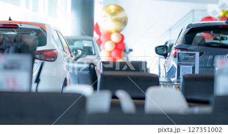 Car parked in luxury showroom. Car dealership office. Car showroom business. New car parked in modern showroom. Auto for sale and rent business. Automobile leasing and insurance. Electric automobile. 127351002