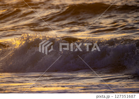Golden Waves at Sunset Over the Serene and Peaceful Ocean, Evoking a Sense of Tranquility 127351687