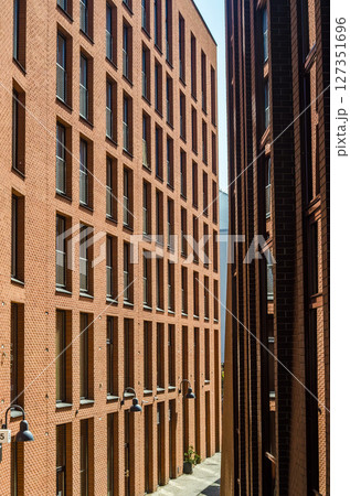 Modern brick apartment buildings with geometric windows in urban cityscape. High quality photo Modern brick apartment buildings with geometric windows in urban cityscape. High quality photo 127351696