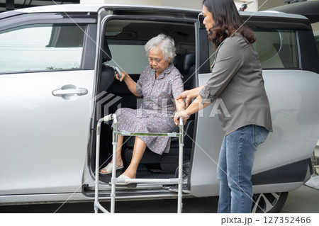 Asian senior woman patient sitting on walker prepare get to her car, healthy strong medical concept. Asian senior woman patient sitting on walker prepare get to her car, healthy strong medical concept. 127352466