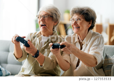Two senior women playing console game 127353533