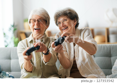 Two senior women playing console game 127353542