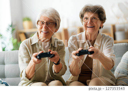 Two senior women playing console game 127353543