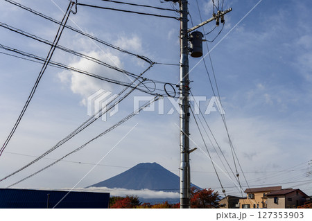 Endless power lines weave across the sky framing Mount Fuji 127353903