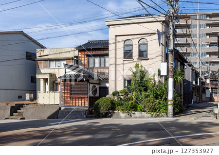 Contrast of traditional wooden houses and modern buildings on a quiet street in Kanazawa Contrast of traditional wooden houses and modern buildings on a quiet street in Kanazawa 127353927