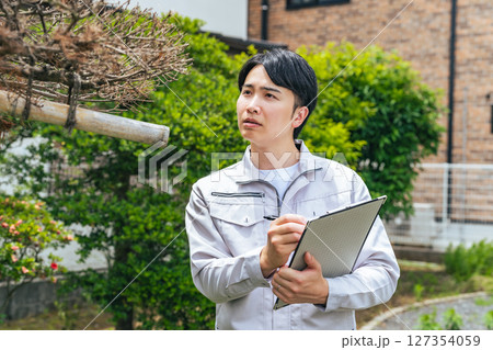 庭木を点検する男性作業員 庭木を点検する男性作業員 127354059