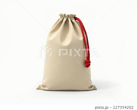 Beige drawstring bag with red cord detail positioned against a plain background Beige drawstring bag with red cord detail positioned against a plain background 127354202
