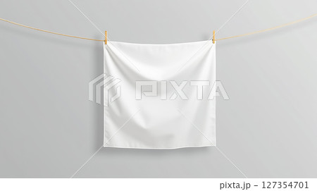 Clean white cloth hanging on a rope in a minimalistic indoor space during daylight hours 127354701