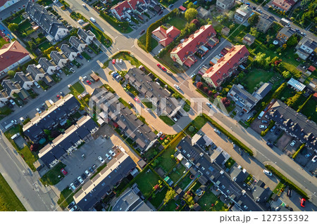 Aerial view of suburban neighborhood with modern houses and green gardens 127355392