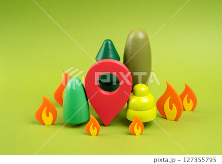 Red location marker in the burning forest. Forest fire monitoring and alarm systems. Early detection, fire monitoring systems, and emergency alert technologies for wildfire management. 127355795