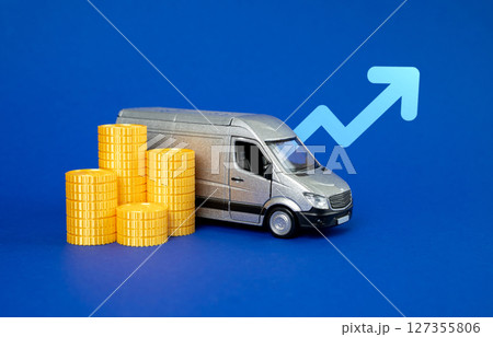 Delivery van with coins and an up arrow. Increase in profitability in the logistics sector. Increase in the number of shipments. Increase in the cost of transporting goods and cargo. Delivery van with coins and an up arrow. Increase in profitability in the logistics sector. Increase in the number of shipments. Increase in the cost of transporting goods and cargo. 127355806