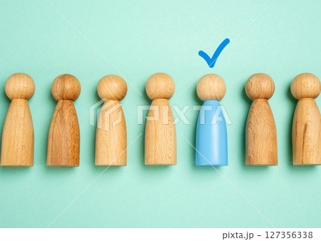 The person is indicated by a check mark above his head. Selecting a candidate or person. Winner. HR processes, recruitment success, promotion, or identifying a winner among many. The person is indicated by a check mark above his head. Selecting a candidate or person. Winner. HR processes, recruitment success, promotion, or identifying a winner among many. 127356338