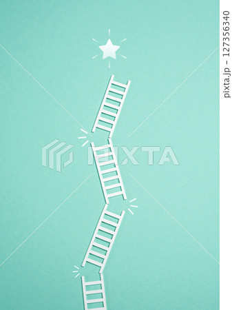 Falling ladder from the success star. Failure to achieve success. Thorny path. Difficult journey, setbacks on the path to achievement, or missed opportunities in personal or professional growth. 127356340
