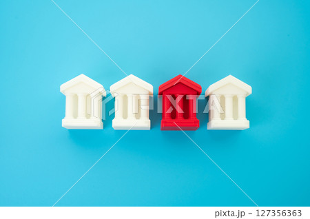 Red bank building among others. Financial problems, low liquidity. Financial crimes and money laundering. Money laundering. Institutional failure in the banking sector. 127356363
