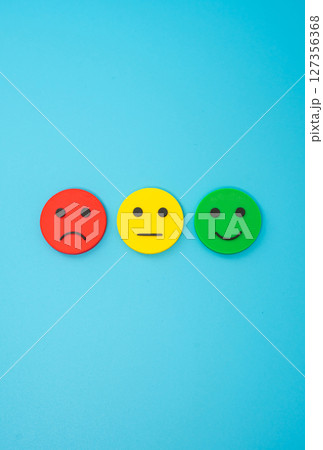 Three emoji faces representing sad, indifferent and happy. Concept for customer feedback, satisfaction ratings, emotional response, or survey results. 127356368