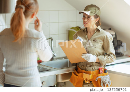 Consultation: Plumber and Homeowner Consultation: Plumber and Homeowner 127356791