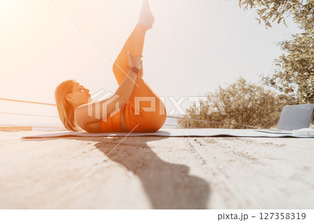 Young Woman Practicing Yoga on a Sandy Beach Young Woman Practicing Yoga on a Sandy Beach 127358319