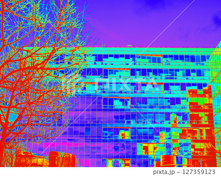 Infrared Thermal Image of Building Facade with Tree. Modern city building in infrared thermal vision for heat analysis. Fragments office and residential buildings in European city with glass facades 127359123
