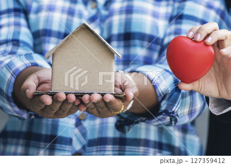 Real estate agent hands holding home business mortgage loan investment property. Hands saving protection home residential concepts. Insurance Agent sale residence ownership household protection care 127359412