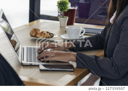 Close up woman hands typing keyboard using computer at home office. Unrecognizable person hands working at home type keyboard online working at home. Businesswoman using internet social media person 127359507