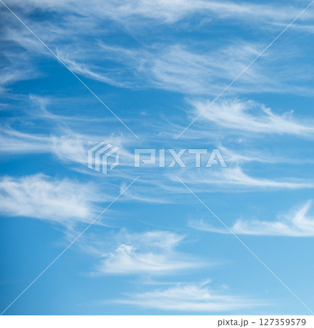 Soft white cirrus clouds against the blue sky 127359579