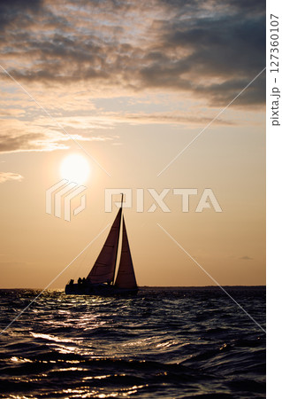 Sailing regatta in the Gulf of Finland at sunset, sailing yacht competing in a race, splashing water from under the boat, teamwork, board the boat 127360107
