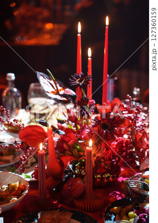 three burning candles on the banquet table in the dark.  127360159