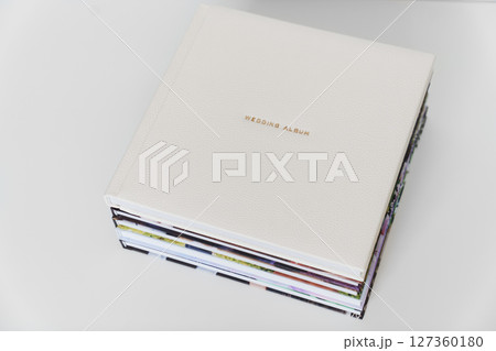 Wedding Album in gold letters on leather cover of book on books with photo cover Wedding Album in gold letters on leather cover of book on books with photo cover 127360180
