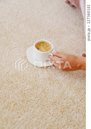 close-up. a cup of coffee on the beige Interior pile carpet. 127360181