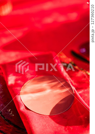 Setting a festive table with a red tablecloth and napkins with a name card. Setting a festive table with a red tablecloth and napkins with a name card. 127360210