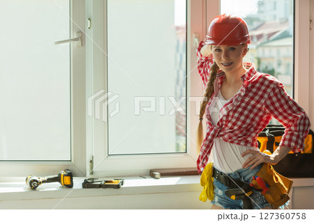 Woman with helmet next to the window 127360758