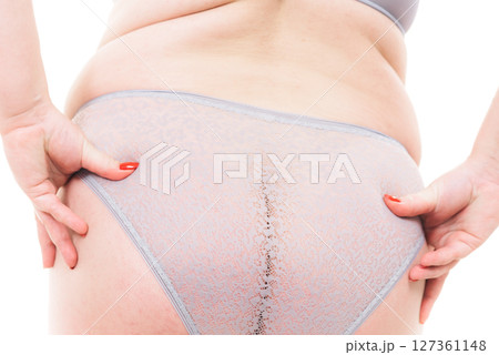 Plus size woman in lingerie back view. 127361148