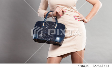 Part body of elegant woman with bag. 127361473