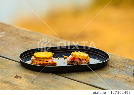 pieces of bread outdoor on wooden table pieces of bread outdoor on wooden table 127361492