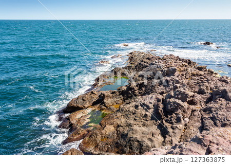landscape of sea coast with rock in summer. seascape background for travel. textured coastline with blue sky above horizon 127363875