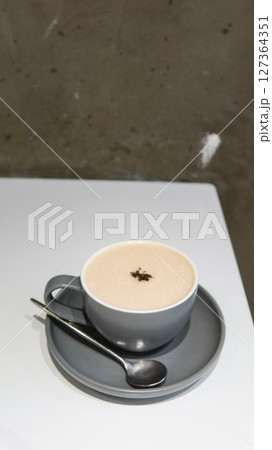 vertical photo of close up of a hot earl grey latte with creamy foam on top in a grey mug with copy space vertical photo of close up of a hot earl grey latte with creamy foam on top in a grey mug with copy space 127364351