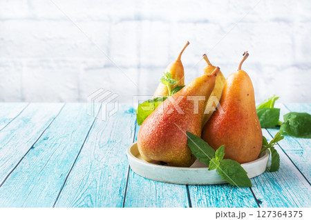 Fresh juicy Pears Conference on blue wooden bright background. Autumn harvest of ripe fruit. copy space 127364375