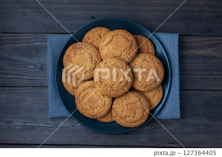 Natural homemade oatmeal cookies on a plate, dark wooden background, copy space. Natural homemade oatmeal cookies on a plate, dark wooden background, copy space. 127364405
