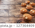 Cookies with cream paste in the shape of monsters for Halloween celebration. Funny homemade faces made of oatmeal cookies and boiled condensed milk. copy space 127364409