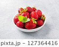 Juicy ripe strawberries in a plate on a concrete background. Sweet healthy dessert, vitamin harvest. copy space. 127364416