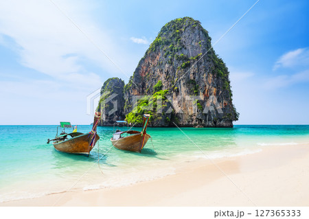Amazing view of Ao Phra Nang Beach with thai traditional wooden longtail boat, white sand and turquoise sea in Krabi province. Ao Nang, Thailand. Amazing view of Ao Phra Nang Beach with thai traditional wooden longtail boat, white sand and turquoise sea in Krabi province. Ao Nang, Thailand. 127365333