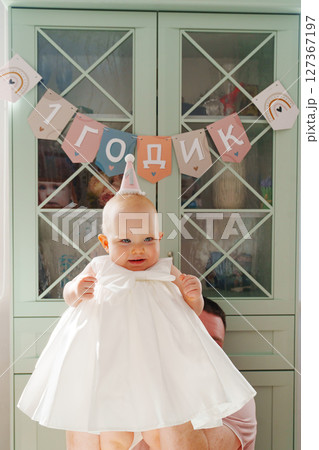 Cute little girl on the background of the inscription in Russian 1 year 127367197