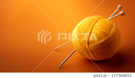 Yellow Ball of Wool With Knitting Needles on Orange Background - Generative Ai 127368655