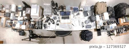 Creative workspace, cameras, bags, tripods in organized chaos, World Photography Day concept 127369327