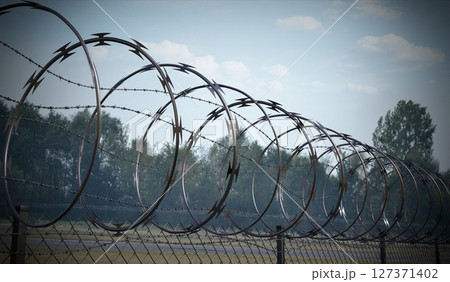 Spiral concertina barbed wire fence - 3d illustration 127371402